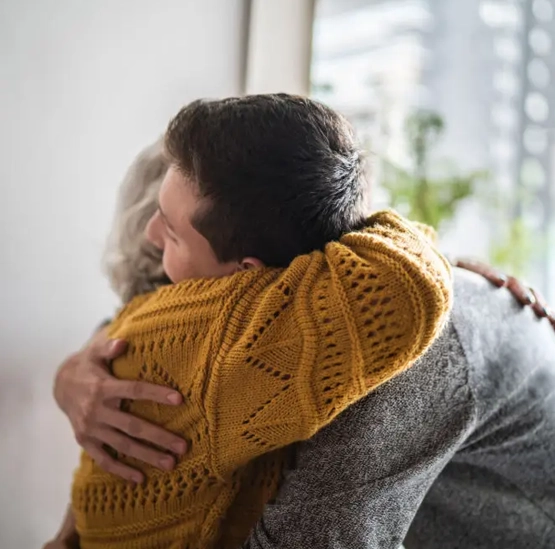 Two people embracing in a quiet supportive moment